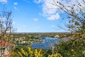 A coastal town with a marina, buildings, and a bridge in the distance. - WAV64 - Charming Waverton Escape | Top-Floor 2-Bed With City & Harbour Views (Waverton)