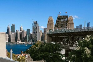 A city skyline with modern buildings and a historic bridge. - FITZ2 - Kirribilli Comfort | 2-Bed Apartment With Harbour Views (Kirribilli)