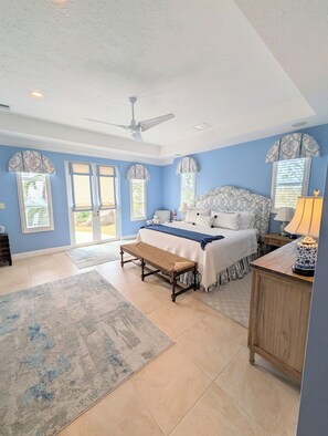 A bedroom with a bed, a bench, a nightstand, and a ceiling fan. -  Pristine 6 bed 6 bath villa in the islands premier gated community!!! (Christiansted)