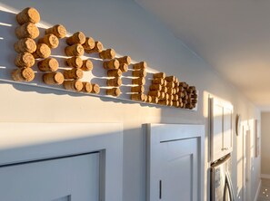 A wall with corks arranged in a pattern. - Isla Ohana: Key Largo, Jacuzzi, Private Yard, Playset, BBQ (Key Largo)