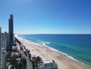 A coastal cityscape with a beach, high-rise buildings, and a clear sky. - Lvl 15 Sunrise + Sunset Views | Pool + Parking (Surfers Paradise)