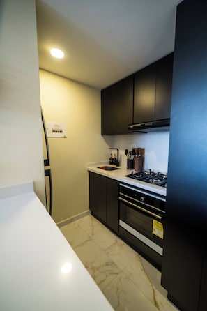 A kitchen with a stove, oven, and sink.