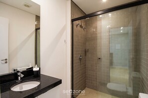 A modern bathroom with a glass-enclosed shower, a black countertop, and a white sink. - Apt. in Condo. w/ Pool in Historic Center Tco0410 (Porto Alegre)