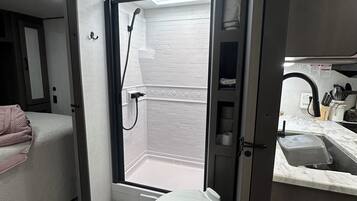 Shower, hair dryer, towels, soap