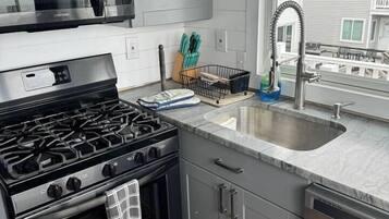 Coffee/tea maker, fridge, cookware/dishes/utensils