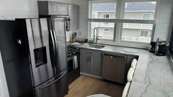 Coffee/tea maker, fridge, cookware/dishes/utensils