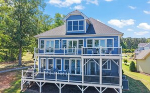 A two-story house with a balcony and large windows. - MAIN-LAKE VIEWS Boat Slip + Community Pool-Golf Cart-Sleeps 12 (Littleton)