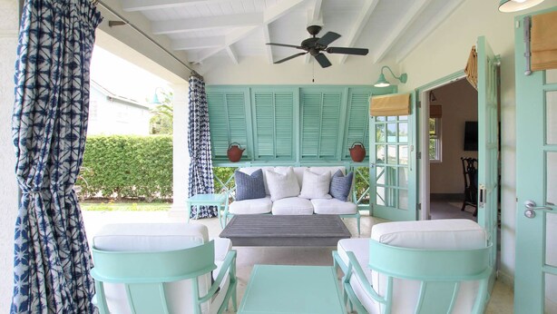 A room with a ceiling fan, a sofa with cushions, a table, and chairs. - Cowrie Cottage | Private Pool | Near Gibbes Beach (Gibbes)