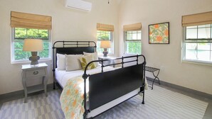 A bedroom with a bed, bedside tables, a ceiling fan, and windows with blinds. - Cowrie Cottage | Private Pool | Near Gibbes Beach (Gibbes)