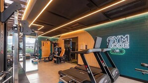 A gym with treadmills, weight machines, and a neon sign reading 'GYM JONDE'. - Studio in Cond. W/pool 480m the Lighthouse Spb0407 (Salvador)