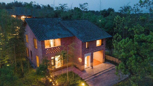 A two-story house with a sloped roof, surrounded by dense greenery. - Haiyang Village Wildwood Resort Wuhan (Wuhan)
