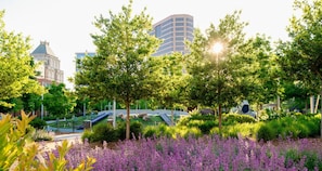 A park with a playground, a bridge, and a building in the background. - Spacious Suite Stay with Pool Access | 6.8 Mi to Civil Rights Museum (Greensboro)