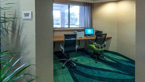 A business library room with two desks, chairs, a printer, and a window with a view of buildings outside. - Indoor Pool & Free Breakfast | Your Gateway to Greensboro's Best Experiences (Greensboro)