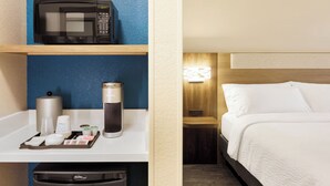A hotel room with a bed, a nightstand, a microwave, a coffee machine, and a tray with coffee cups and a tea kettle. - Free Breakfast & Seasonal Pool |Swim, Recharge & Rest After a Day of Exploring (Ruckersville)