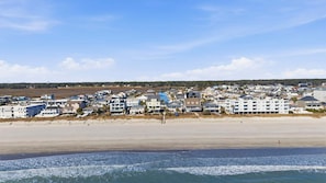 A coastal town with beachfront properties and a sandy beach. - Pal's Palmetto Place - 3BR Bungalow w/ Ocean Views (North Myrtle Beach)
