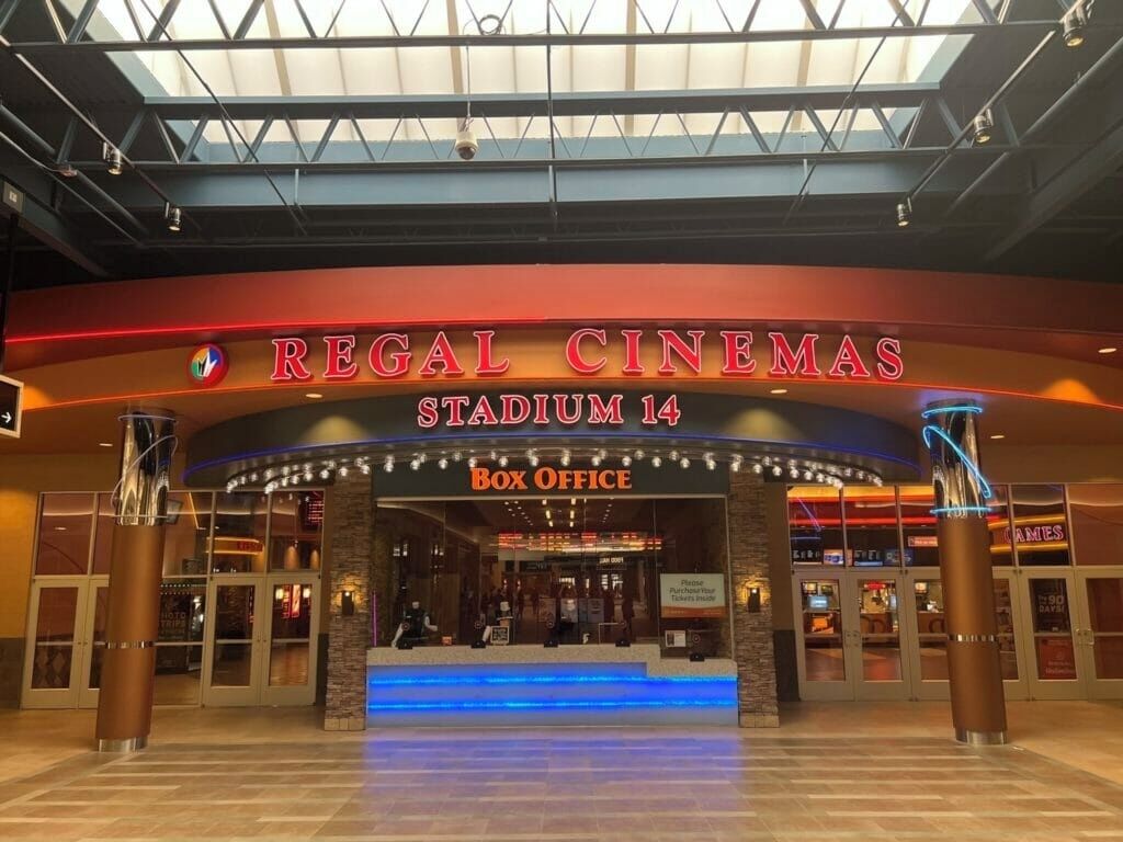 Regal Cinemas Stadium 14 with a Box Office entrance, large glass doors, and a modern interior design.