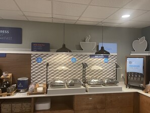 A breakfast area with a marble backsplash, a coffee machine, and a water dispenser.