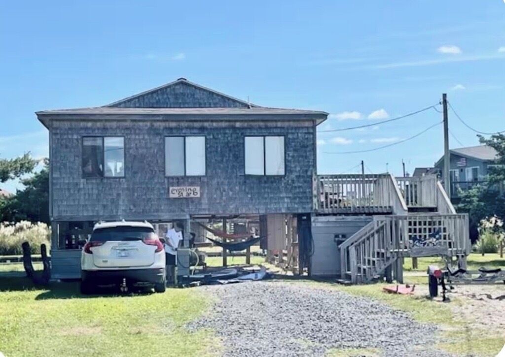 A two-story house with a visible garage and a covered porch area.