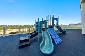 A playground with slides and climbing structures on a rooftop. - Turquoise Place D2201 | Pools, Lazy River + Balcony Hot Tub & Grill (Orange Beach)