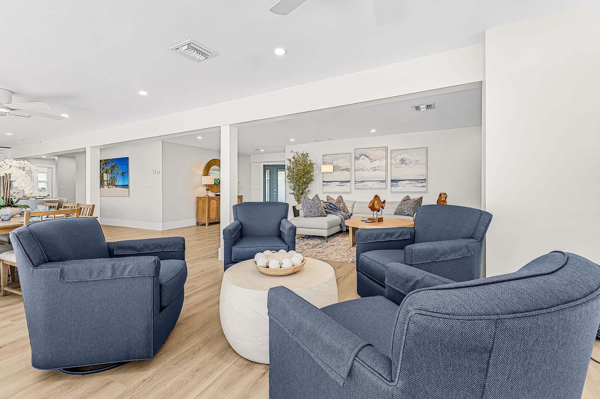 A modern lounge area with sofas, a coffee table, and artwork on the walls.