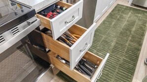 A kitchen with a built-in oven, a microwave, and a stainless steel dishwasher.