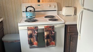 Eine Küche mit einem weißen Herd, einem Toaster und einem Kühlschrank.