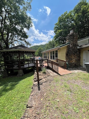 A gazebo, a stone chimney, and a wooden deck. - Adorable 2-bedroom lake house with Lake Access near Confluence (Confluence)