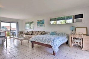 A bedroom with a bed, a desk, a chair, and a window. - Two Balconies • Cozy Haiku Studio (Haiku-Pauwela)