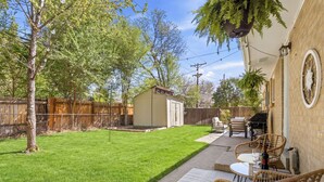 A backyard with a lawn, a barbecue area, and outdoor furniture. - Dog-Friendly Arvada Home with Fire Pit, 18 Min to Red Rocks & Near Denver (Arvada)
