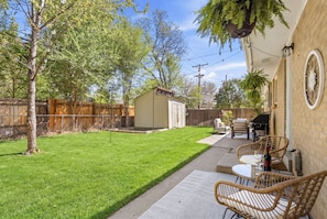 A backyard with a lawn, a barbecue area, and outdoor furniture. - Dog-Friendly Arvada Home with Fire Pit, 18 Min to Red Rocks & Near Denver (Arvada)