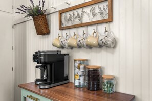 A kitchen with a coffee maker, mugs, and jars on the counter. - Dog-Friendly Arvada Home with Fire Pit, 18 Min to Red Rocks & Near Denver (Arvada)