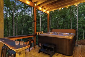 A wooden deck with a hot tub, bar area, and outdoor seating. - Modern Luxury-Couples Retreat-Hot Tub-Private Gym-Speakeasy-Close to Downtown (Blue Ridge)