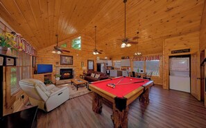 A cabin interior with a pool table, fireplace, television, and a 'Welcome' sign. - Fall Colors! Hot Tub Gas Fire Pit Great Location (Pigeon Forge)
