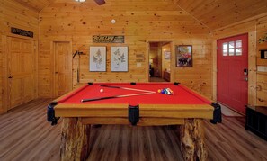 A pool table in a cabin with wooden walls and a red door. - Fall Colors! Hot Tub Gas Fire Pit Great Location (Pigeon Forge)
