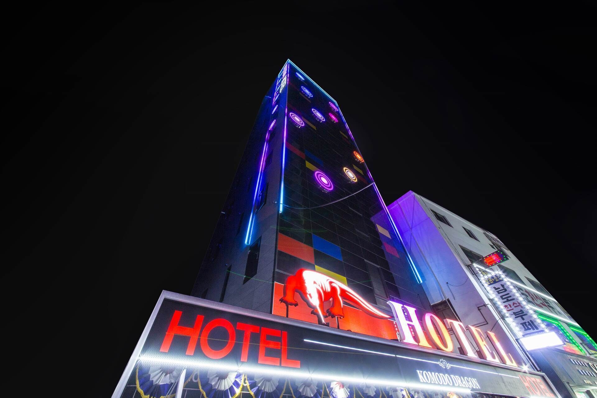 A hotel with a prominent 'HOTEL' sign and a 'KOMODO DRAGON' logo.