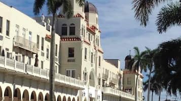 A multi-story hotel with a central courtyard, balconies, and a dome structure.