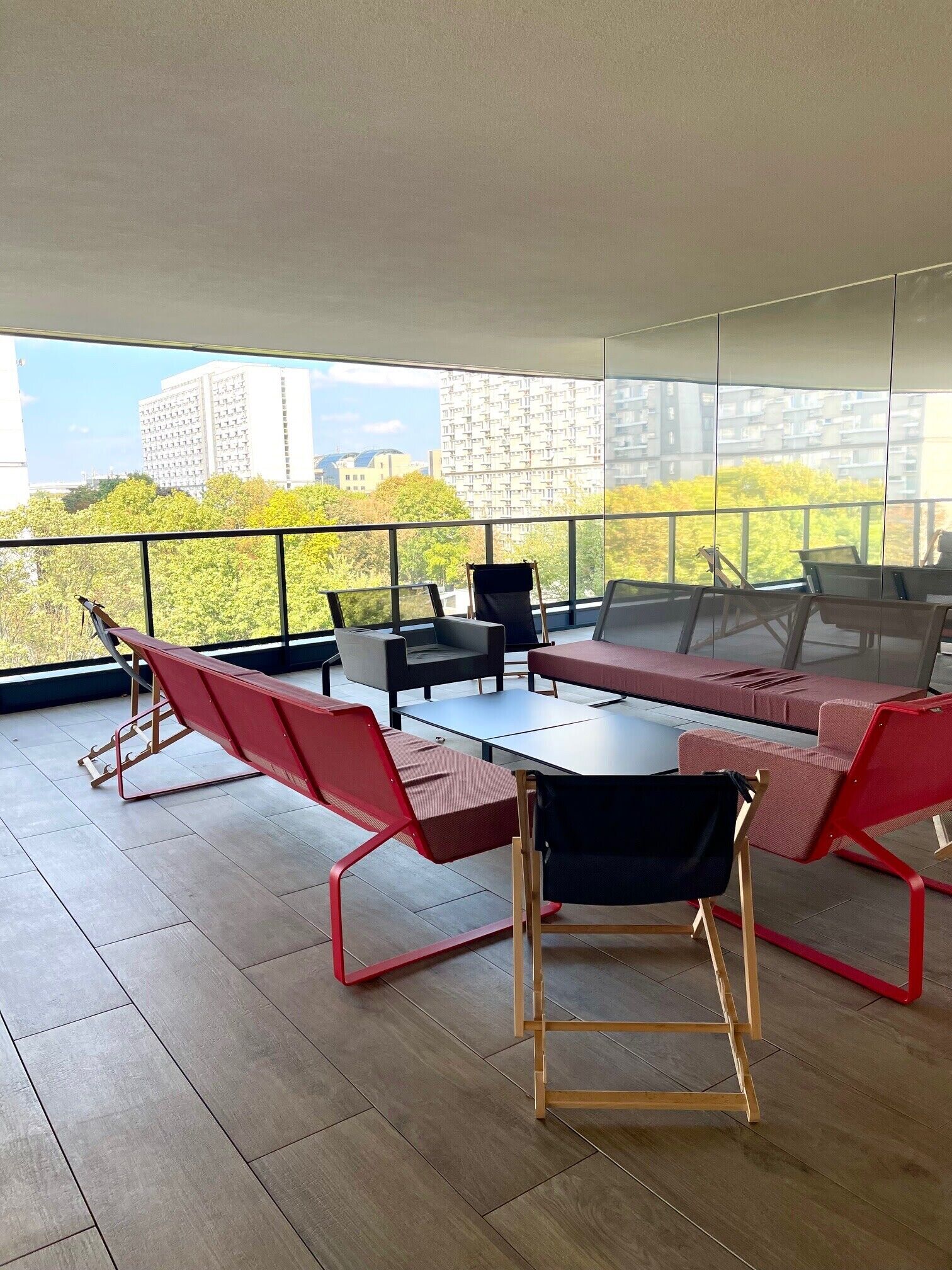 A modern outdoor seating area with a view of a cityscape.