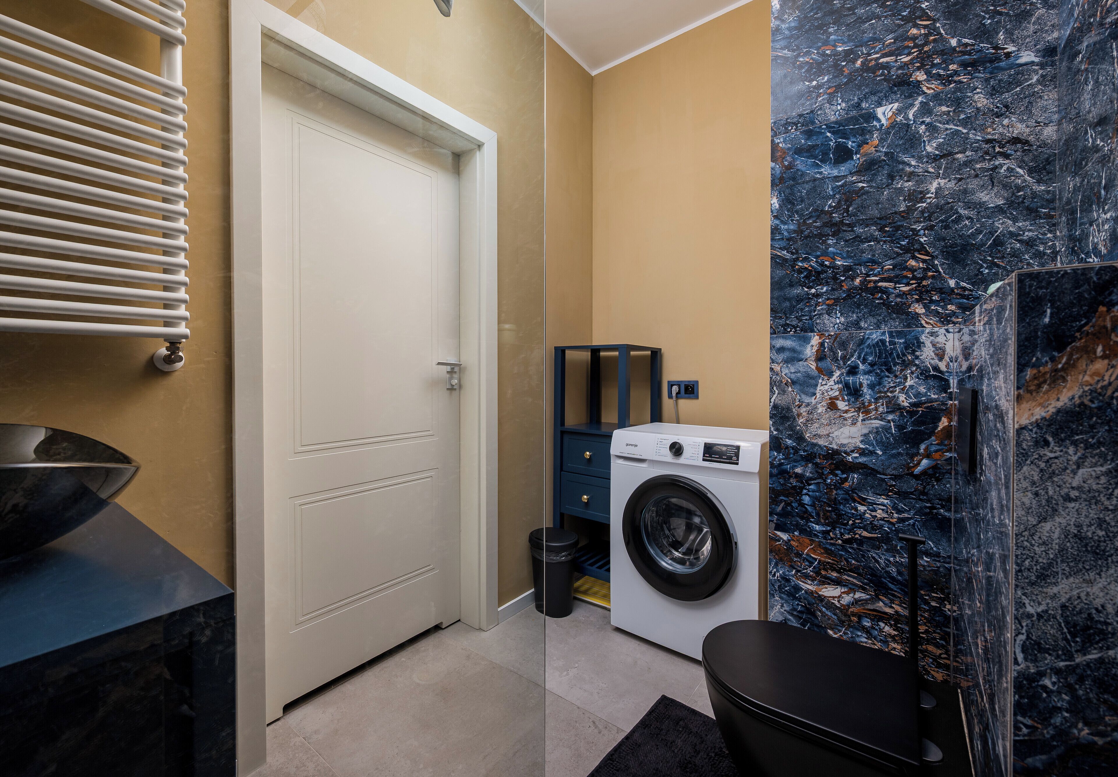 A laundry room with a washing machine, a dryer, and a door.