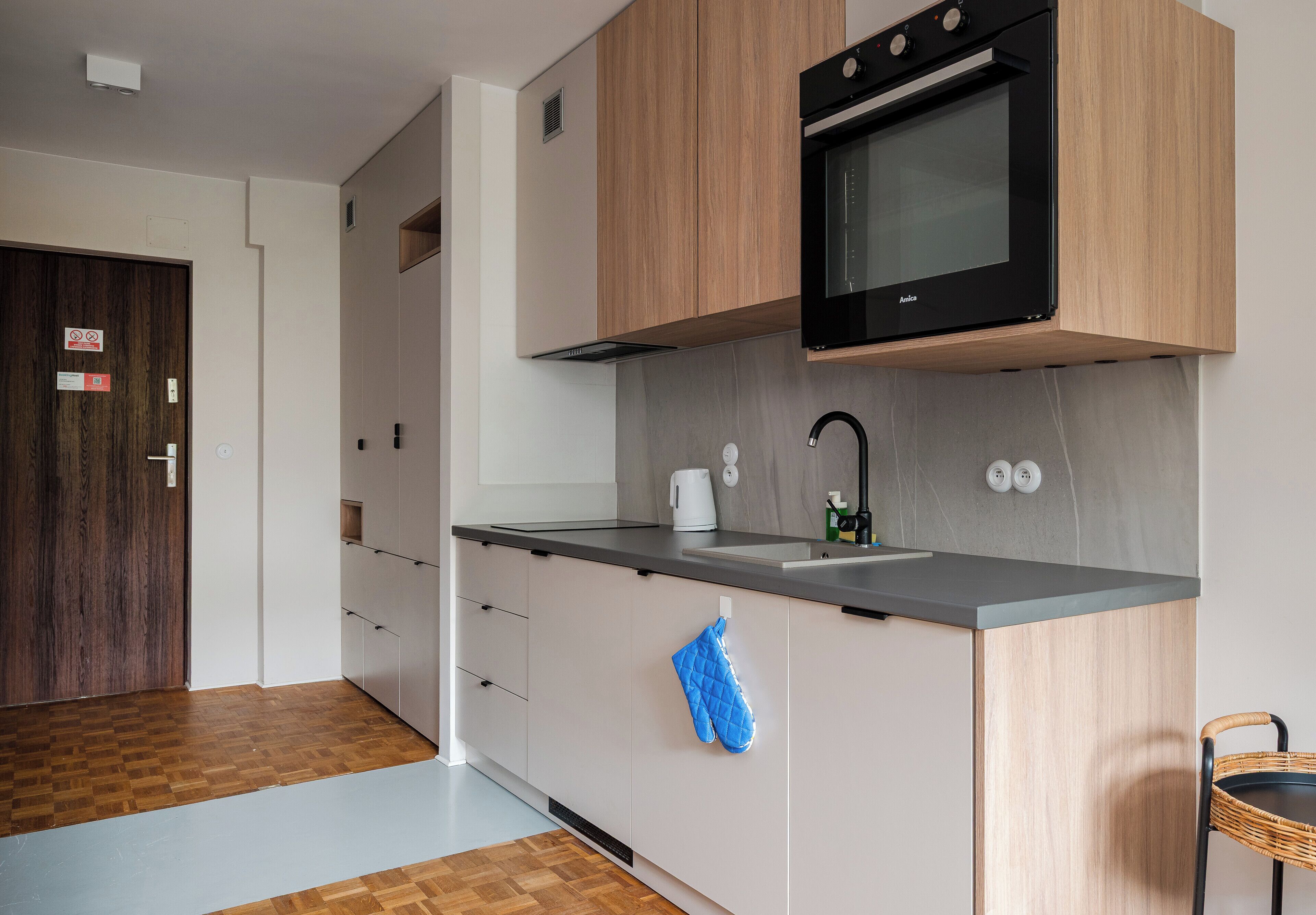 A modern kitchen with a built-in oven, a sink, and a countertop.