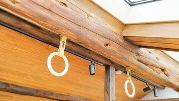 A wooden ceiling with exposed beams and a skylight.