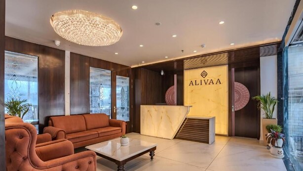 A modern lobby with a reception desk, seating area, and large windows. - Alivaa Hotel, Mcleodganj With Best Dhauladhar View (Dharamshala)