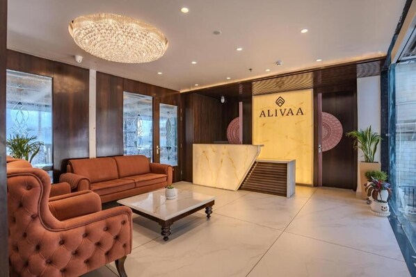 A modern lobby with a reception desk, seating area, and large windows. - Alivaa Hotel, Mcleodganj With Best Dhauladhar View (Dharamshala)