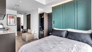 A modern hotel room with a large bed, a wardrobe, a desk, and a seating area. - Pied A Terre With Roof Pool (Miami)