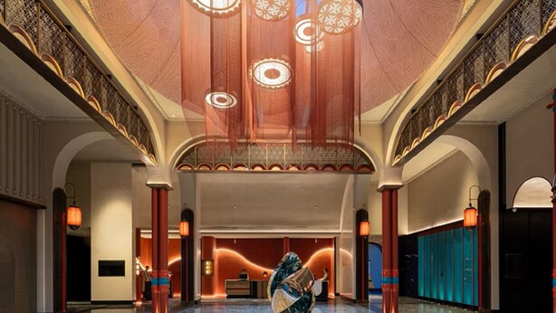 A spacious lobby with a marble floor, a reception desk, and a large decorative sculpture. - Hotel Indigo Sayram Lake by IHG (Bole)