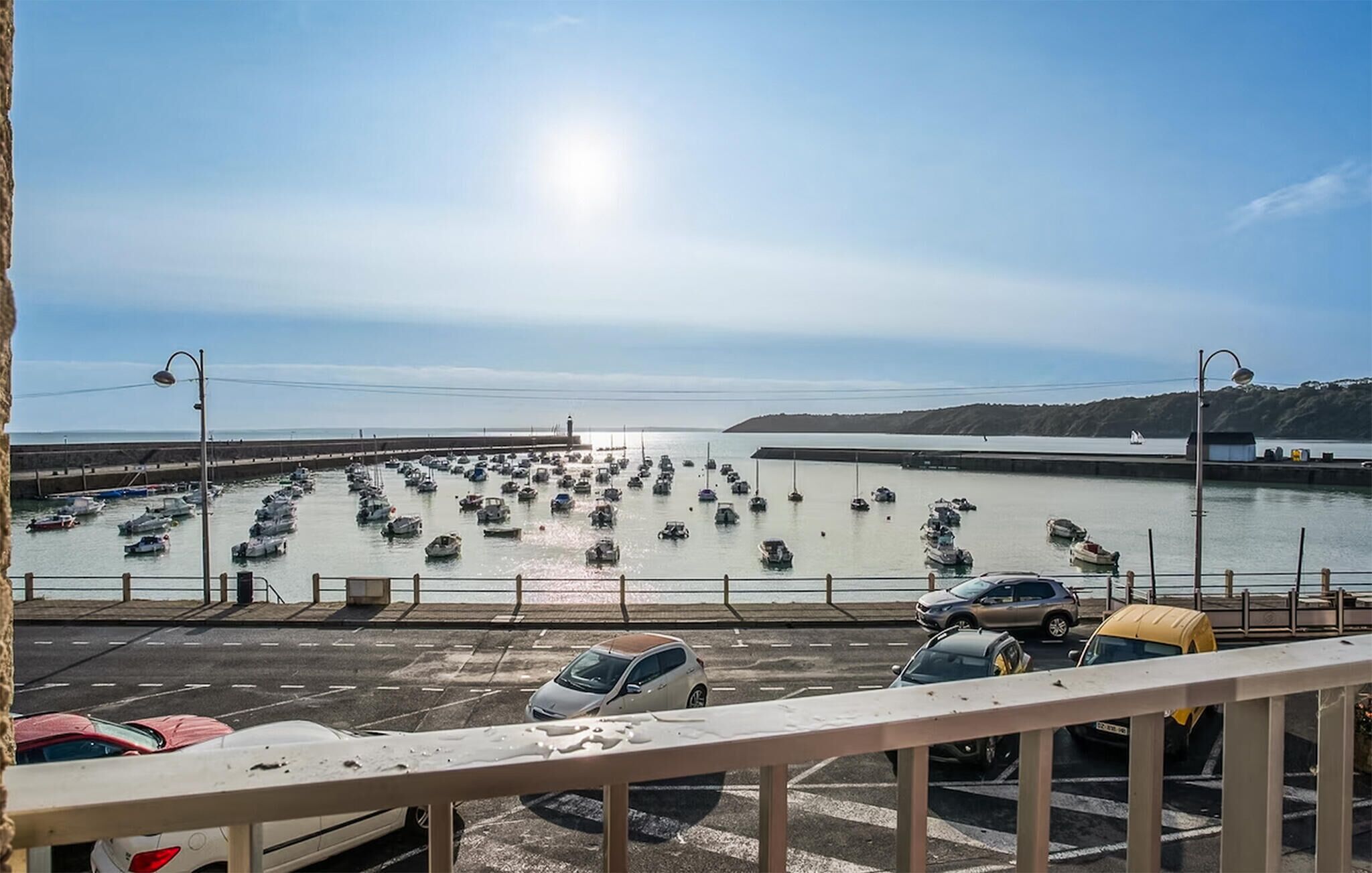 A marina with boats docked and a road leading to it.