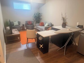 A compact living space with a kitchenette, a dining area, and a seating area with two sofas and a coffee table. - Home Away From Home, AC, Private Parking, 2 Bathrooms (Calgary)