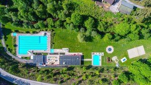 An aerial view of a resort with a large swimming pool, a tennis court, and a children's play area. - Apartment on Uhrenstraße (Lenzkirch)