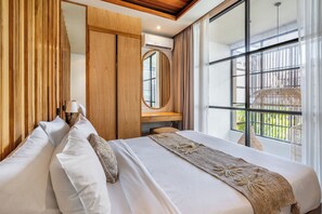 A hotel room with a large bed, wooden paneling, a round mirror, and a view of the outdoors. - The Louver Canggu Exotic Bali Properties (Canggu)