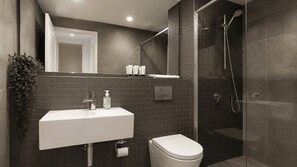 A modern bathroom with a white sink, toilet, and glass-enclosed shower. - The Lakeview on Grazier (Belconnen)