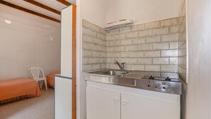 A compact kitchenette with a sink, a small countertop, and a cabinet. - 1 bedroom nice home in CALCATOGGIO (CALCATOGGIO)